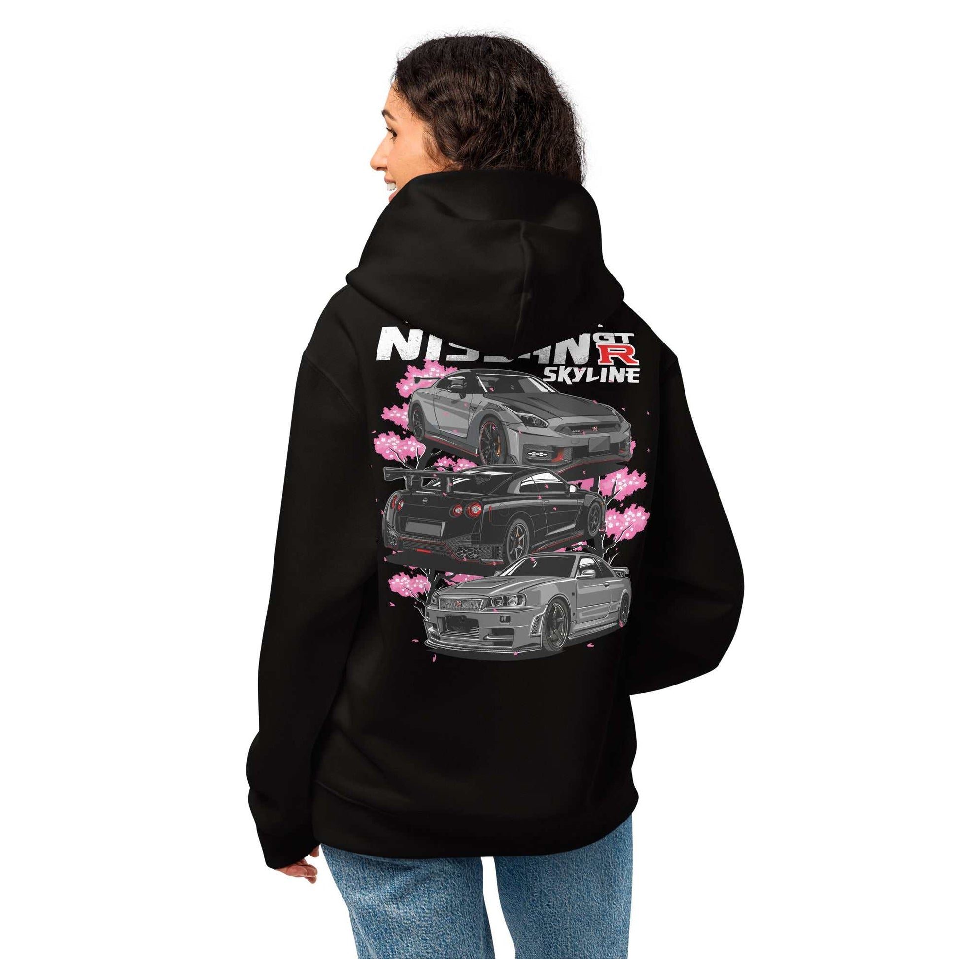 Woman wearing black Skyline Legends Sakura GT-R Hoodie with detailed GT-R car graphic and cherry blossoms on the back