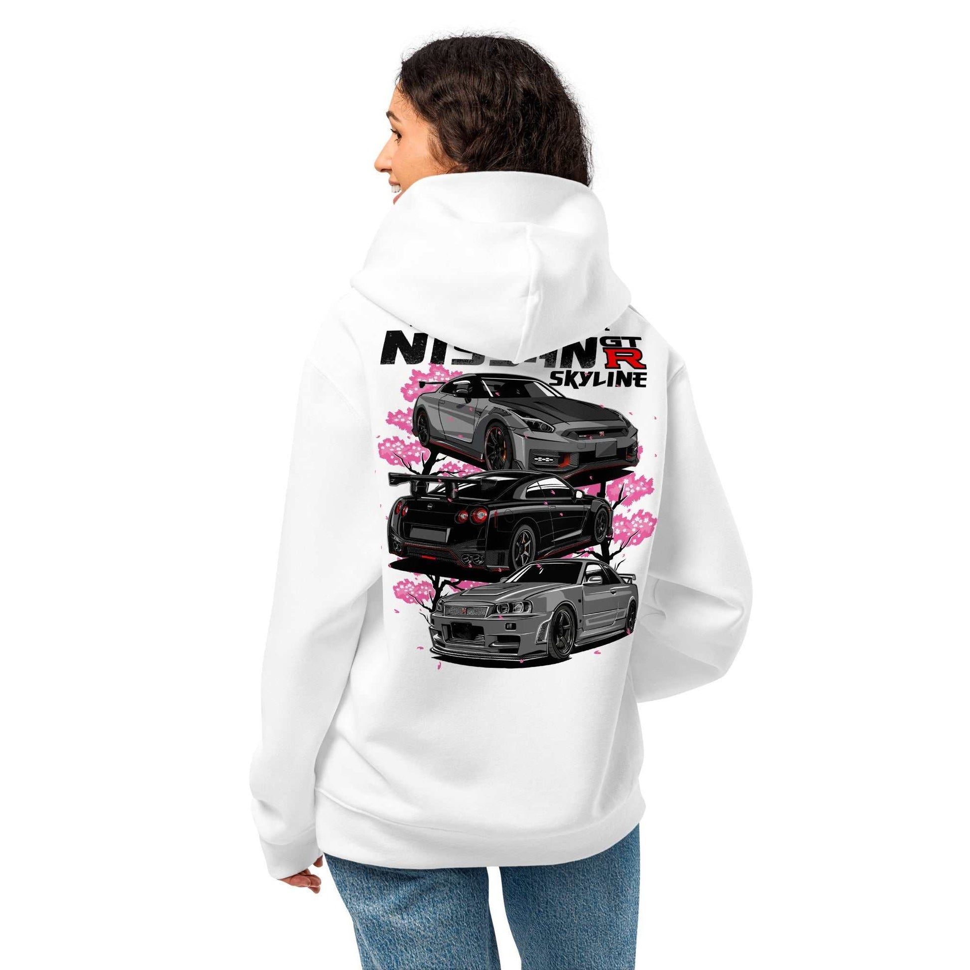 Woman wearing white Skyline Legends Sakura GT-R Hoodie with detailed GT-R car graphic and cherry blossoms on the back