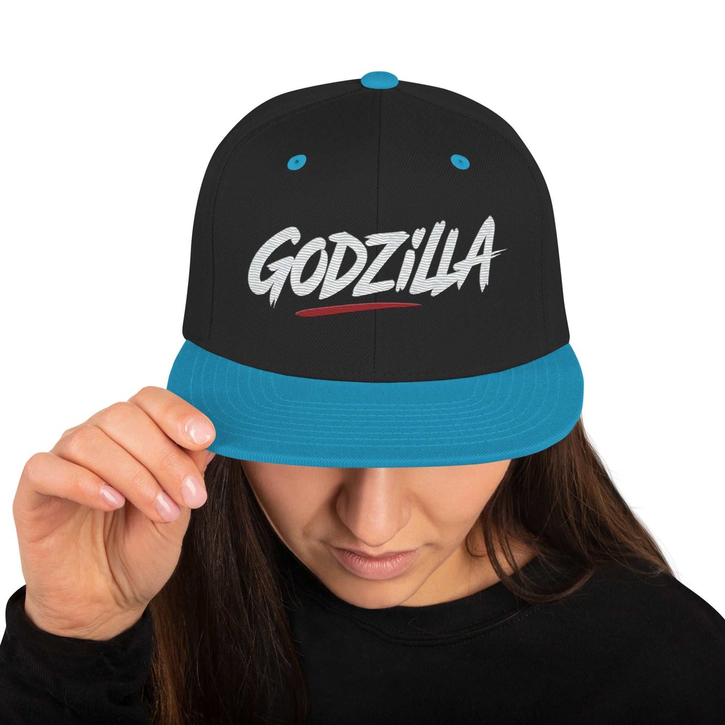 Black and blue Godzilla Flat Brim Hat with embroidered lettering worn by person