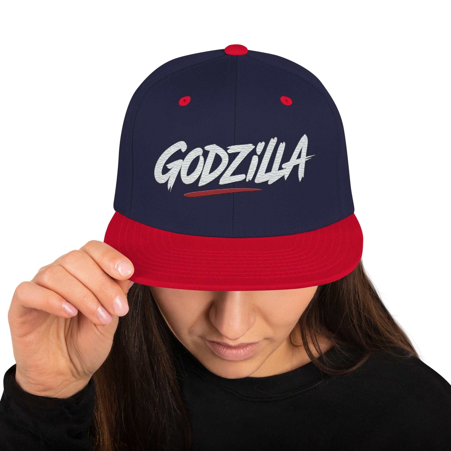 Woman wearing Godzilla Flat Brim Hat with navy crown and red brim, embroidered Godzilla logo on front