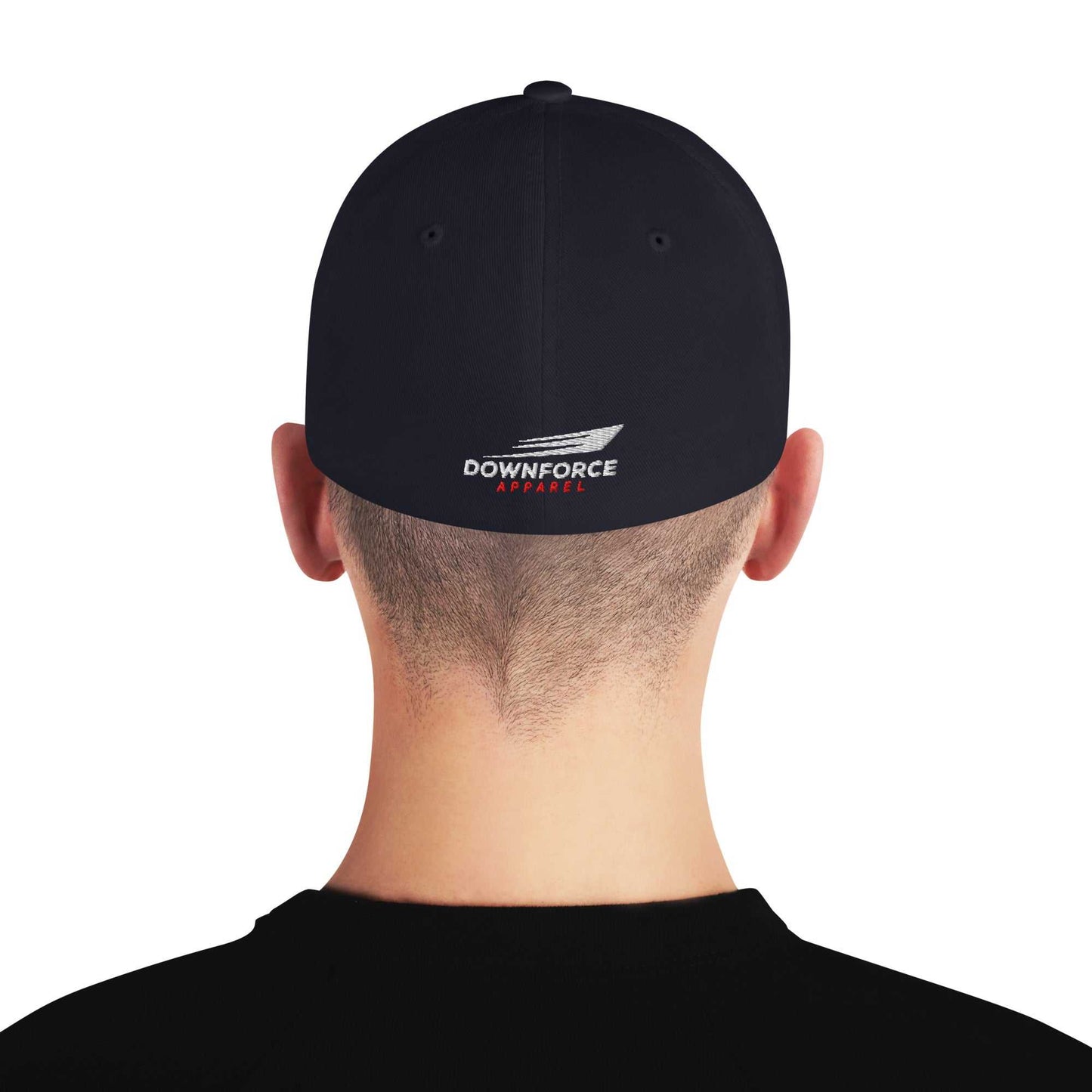 Back view of black Downforce Apparel Flexfit cap with embroidered logo on elastic stretch band worn by person