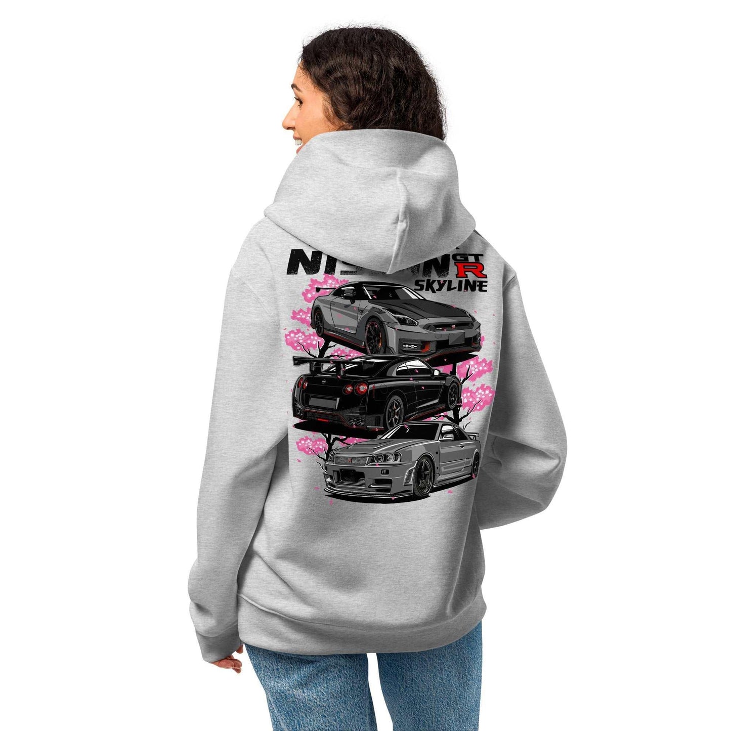 Person wearing Skyline Legends Sakura GT-R Hoodie with black GT-R cars and cherry blossom graphic on back in gray hoodie
