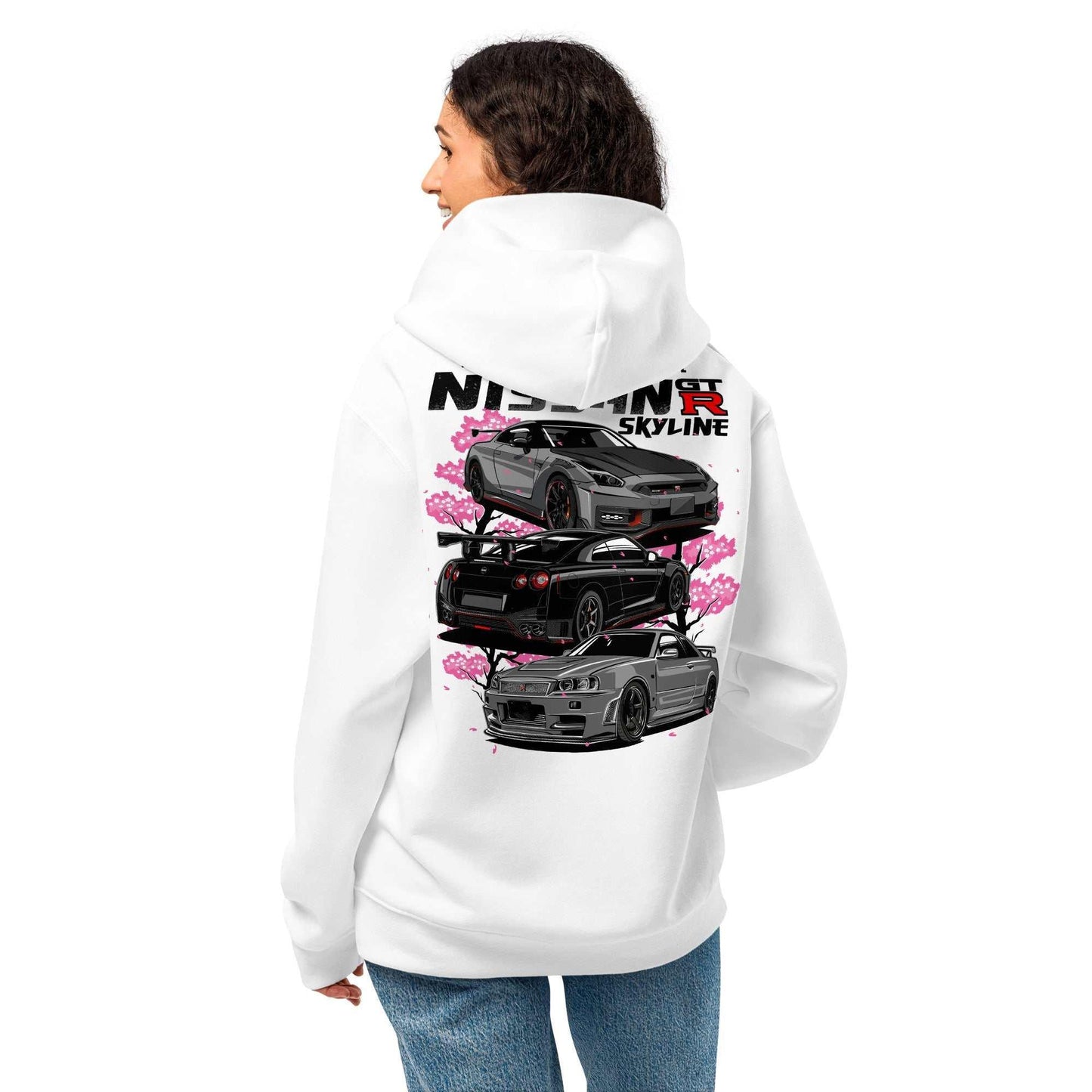 Woman wearing a white Skyline Legends Sakura GT-R Hoodie with a back graphic of three Nissan GT-R cars and pink cherry blossoms