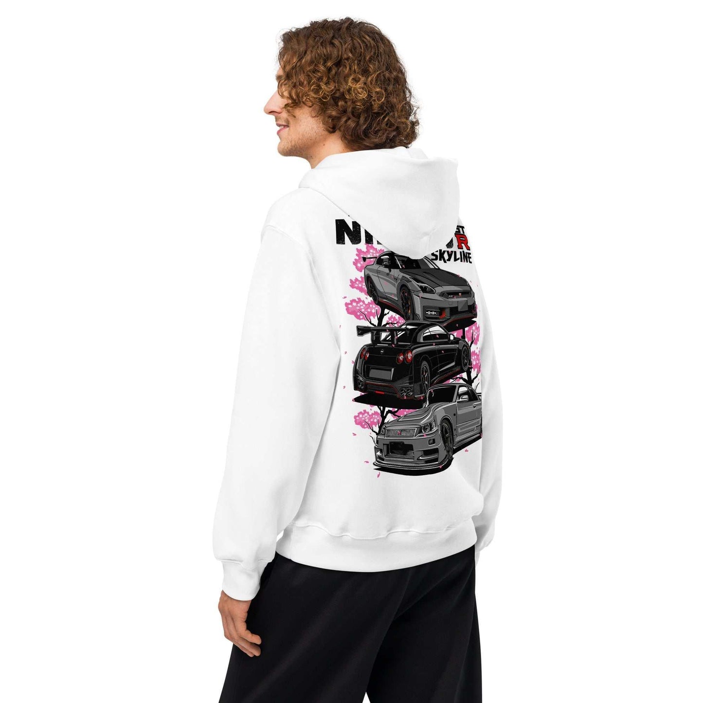 Man wearing white Skyline Legends Sakura GT-R Hoodie with detailed black GT-R cars and pink cherry blossoms design on the back