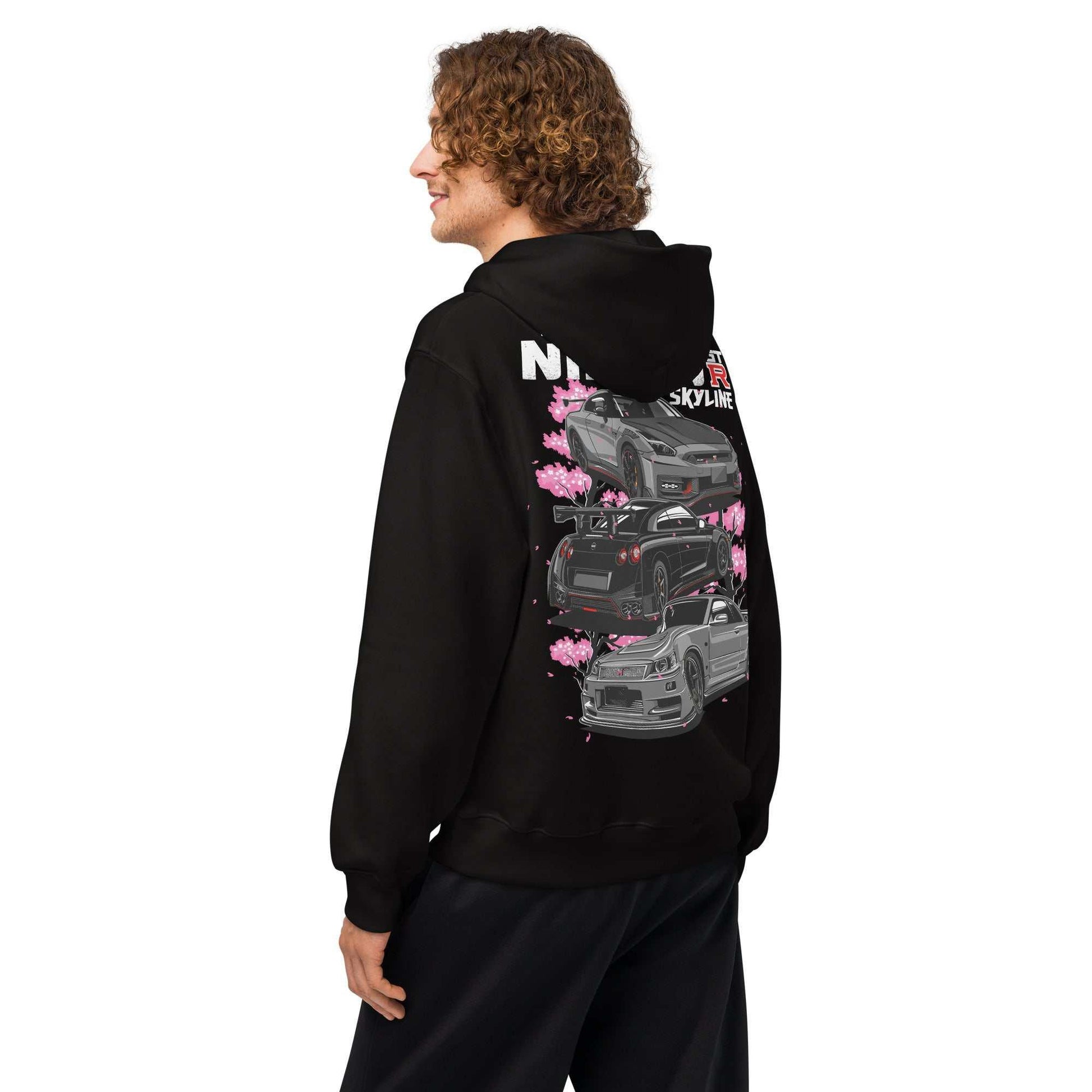 Man wearing black Skyline Legends Sakura GT-R Hoodie with GT-R car and cherry blossom graphic on back