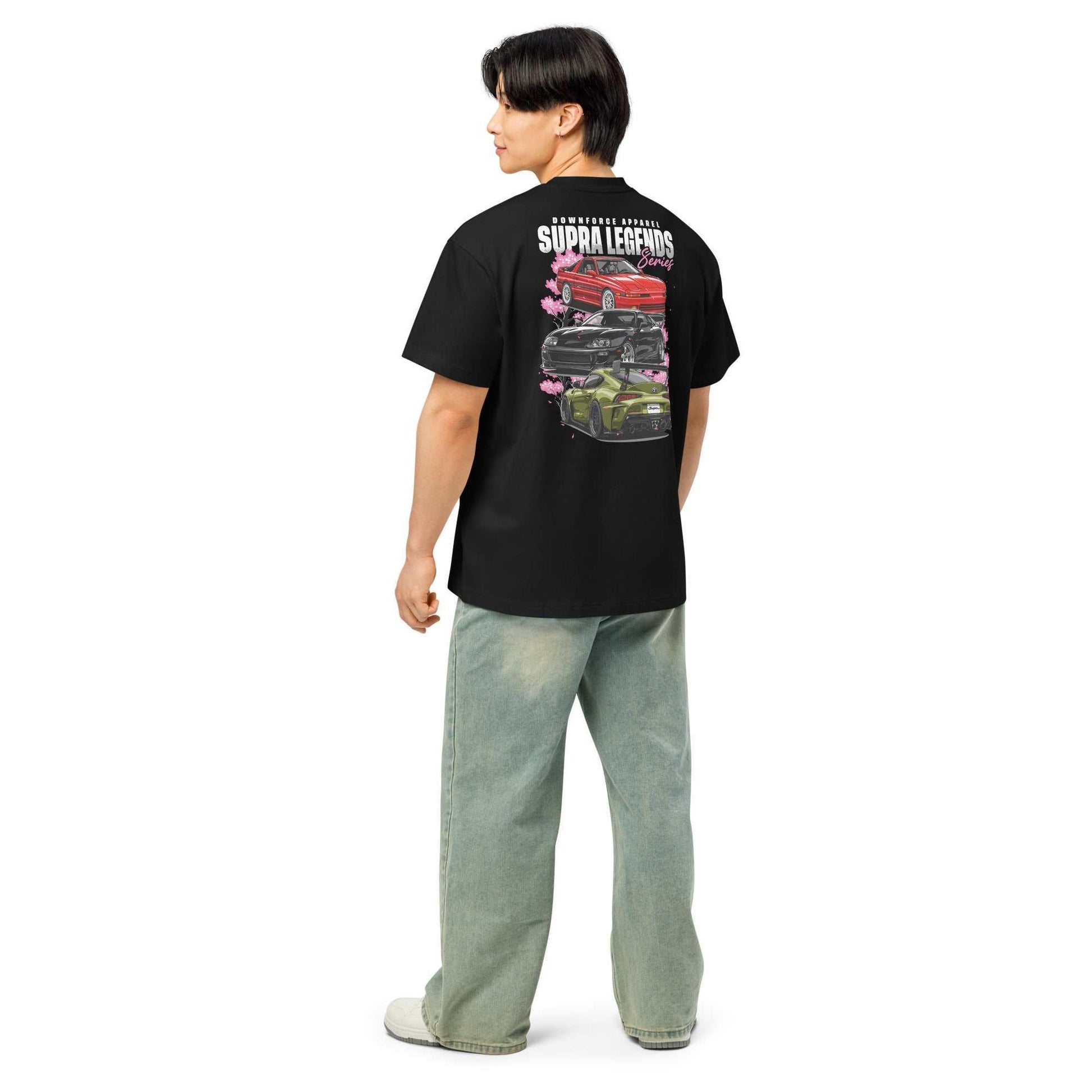 Man wearing black Supra Legends Series JDM streetwear tee with car graphics on the back.