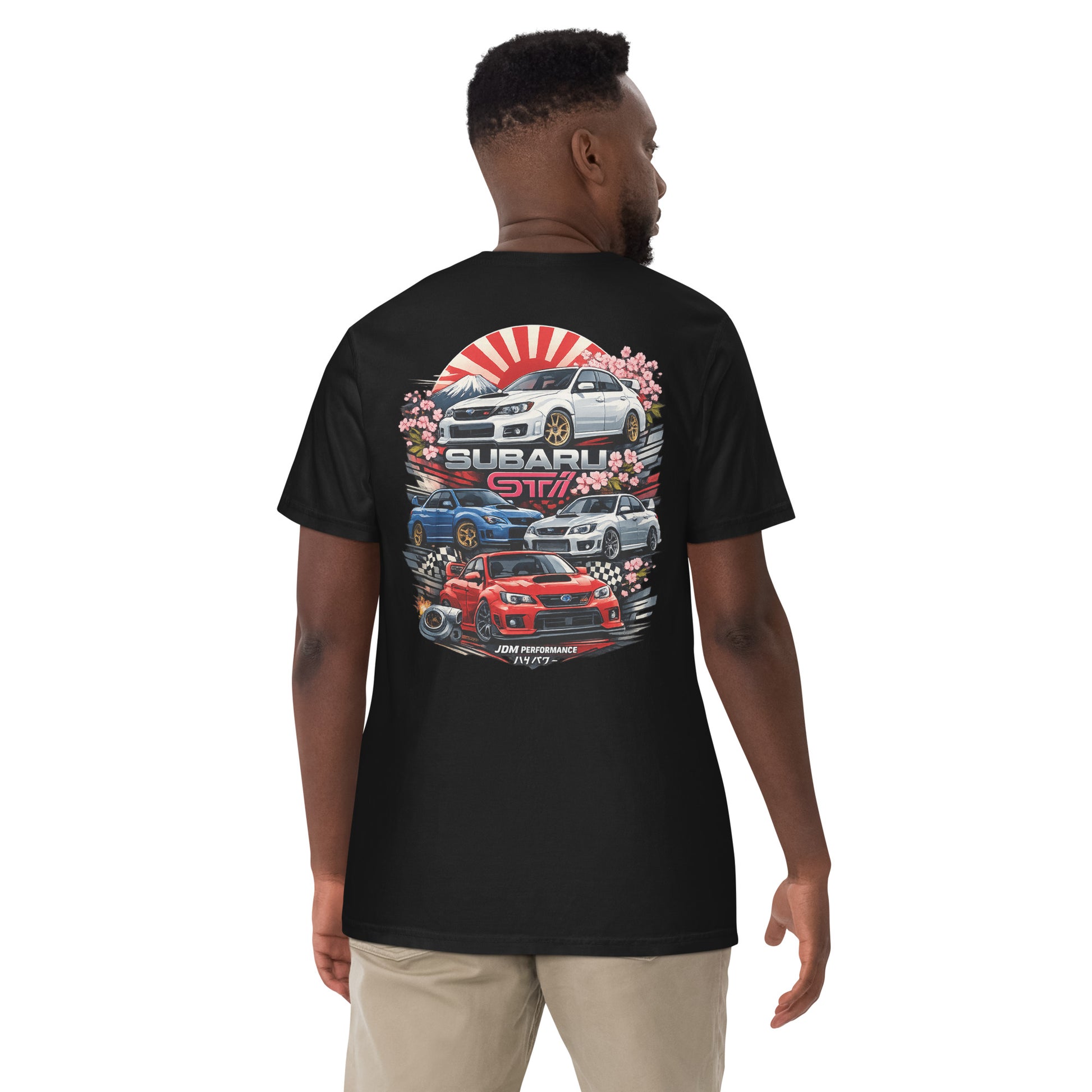 Man wearing black graphic t-shirt with Subaru STI JDM car designs and Japanese motif on back