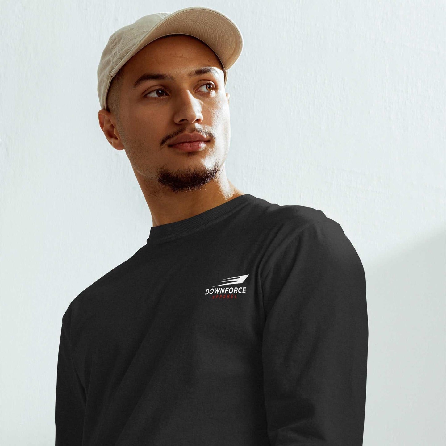 Man in black motorsport streetwear long sleeve tee with cap, modern automotive shirt style